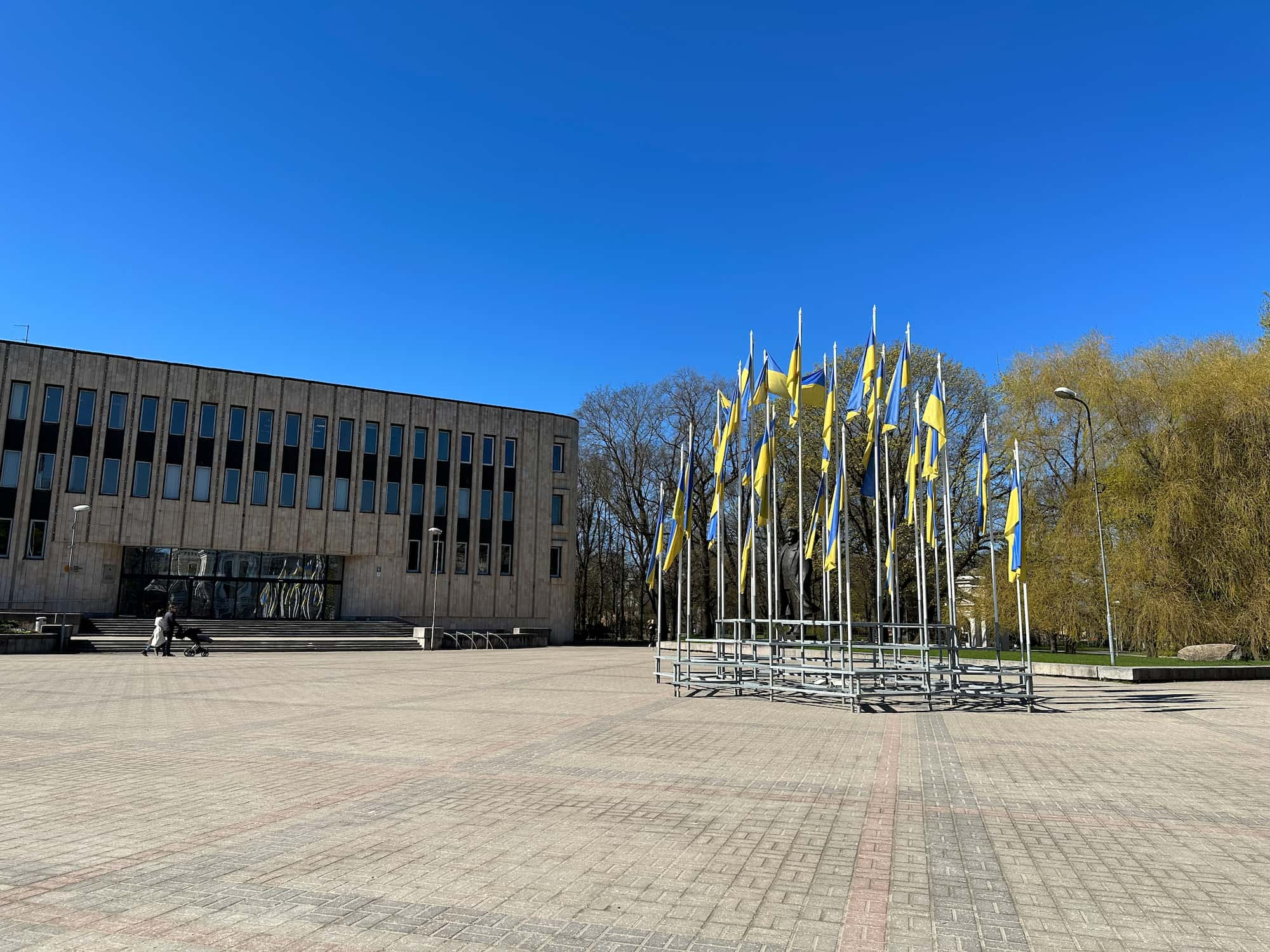 Aforementioned building with a lot of Ukrainian flags in front of it